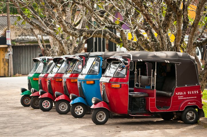 Bendotta Sri Lanka row of red blue and green empty tuk tuks 