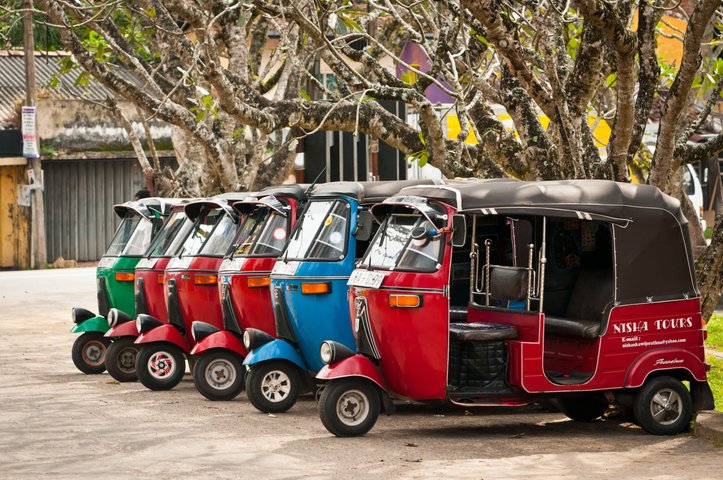 Bendotta Sri Lanka row of red blue and green empty tuk tuks 